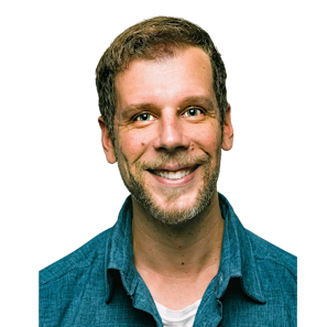 Portrait of Matthew Davis, smiling, in a business setting